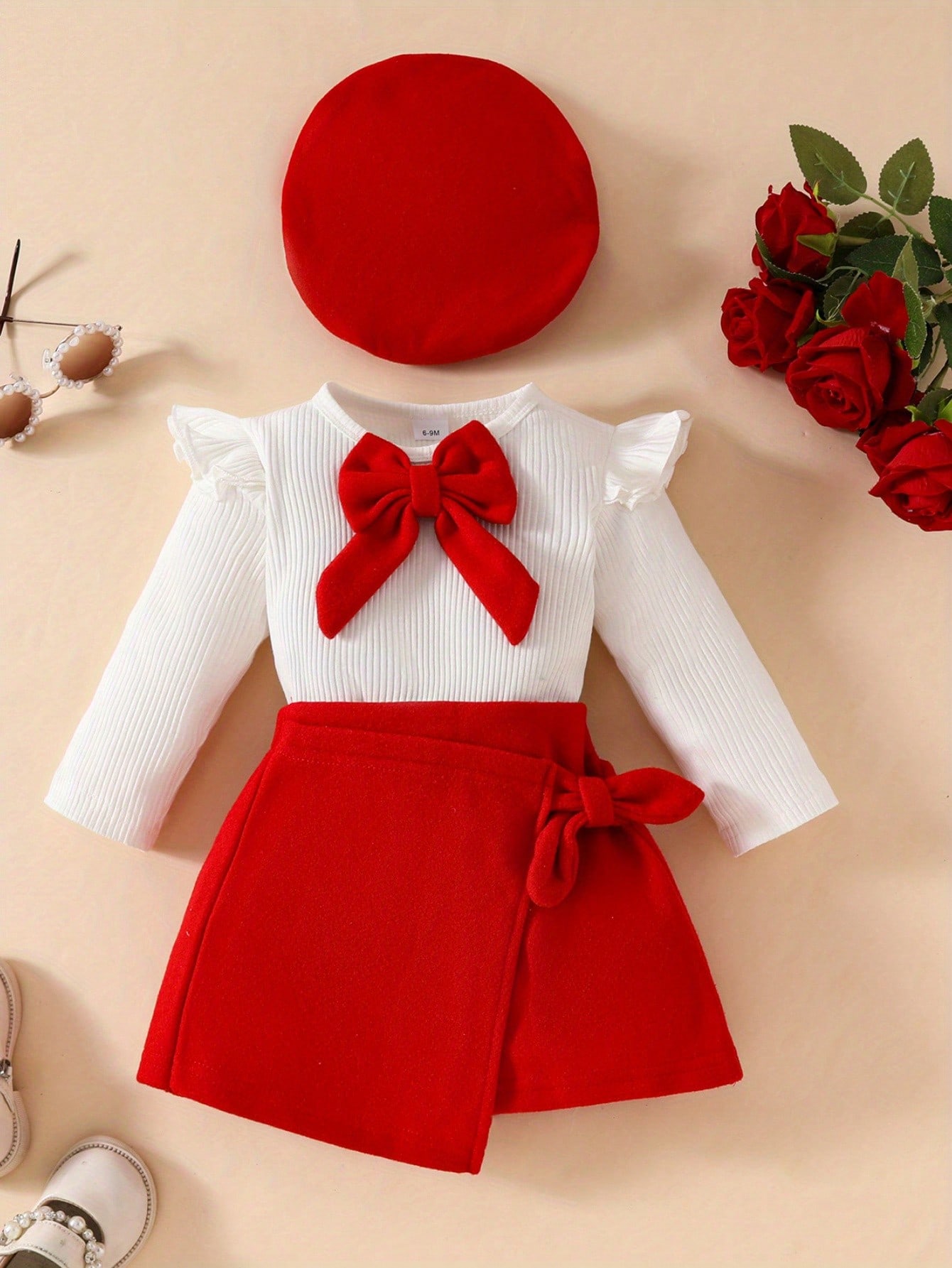 White bow top with red skirt and matching beret
